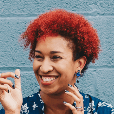 woman smiling while pointing on her right side