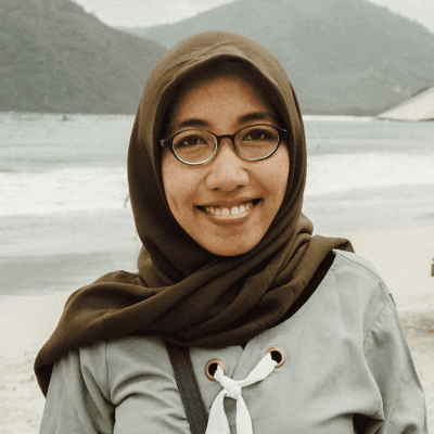 a woman standing on top of a sandy beach