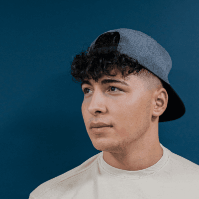 a young man wearing a hat and a t - shirt