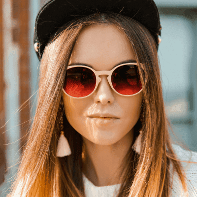 woman in white knit sweater and black fitted cap