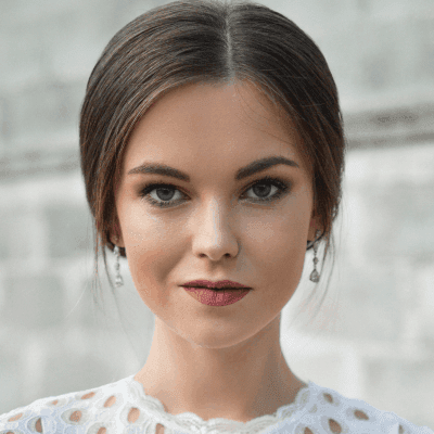 shallow focus photo of woman standing near wall