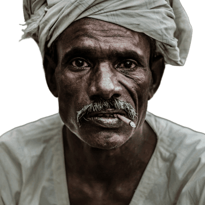 man wearing gray turban smoking cigarette in closeup photography