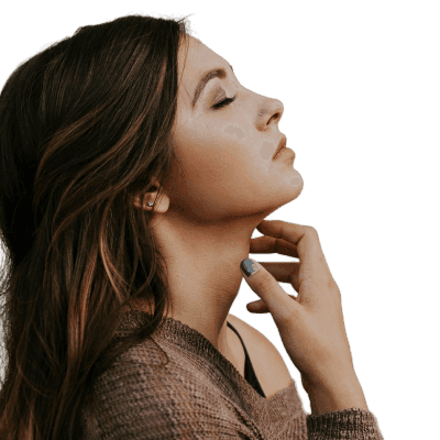 woman in brown long-sleeved top standing beside wall