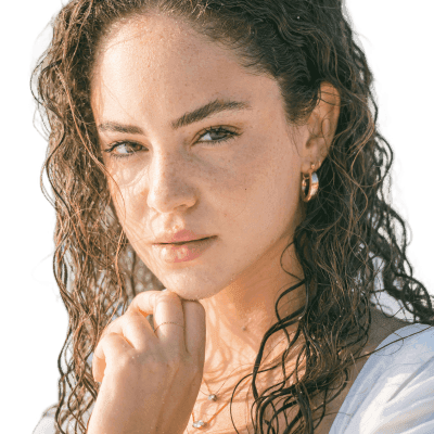 a woman with curly hair wearing a white dress