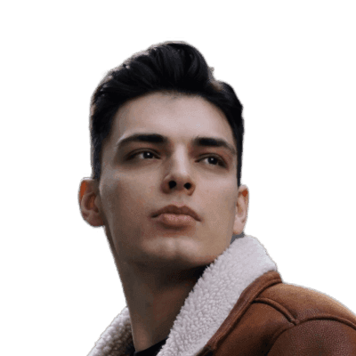 man in brown coat standing beside gray concrete wall during daytime